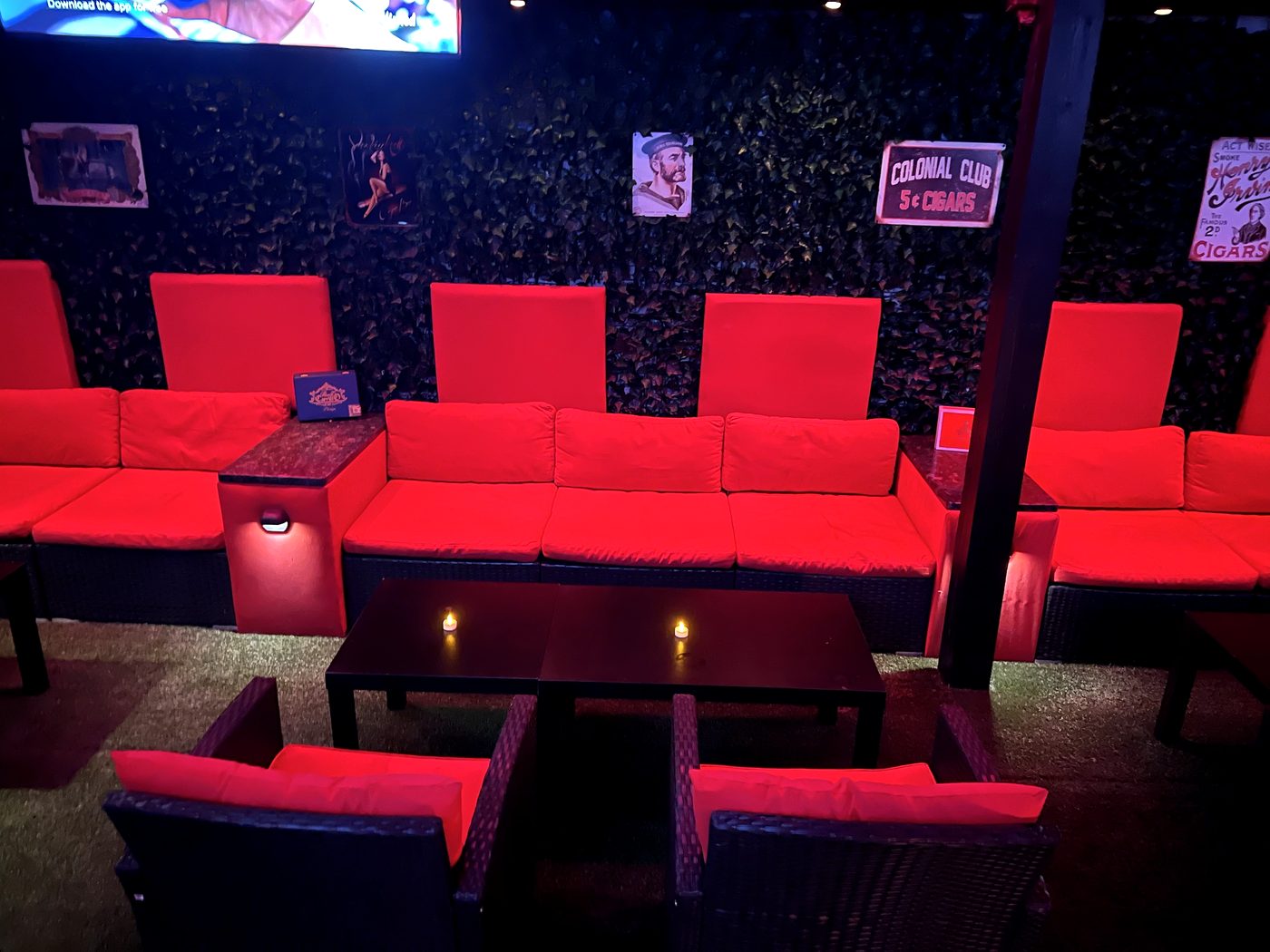 Wide view of the red lounge under the draped ceiling